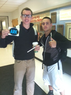 One lucky ARK recipient holds up an ARK sticker after having coffee paid for in Stark.