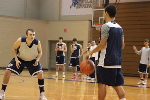 Guard Devin Dunn, at left, gets set on defense during a recent practice session for the Colonels at the Marts Center. The 6-2 guard from Staten Island will be one of the team captains for the 2013-14 season.