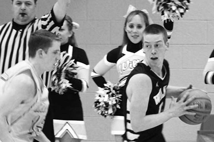 Alec Wizar confuses an Eastern opponent as he decides whether to spread the ball around or drop another three-point bucket himself over the players head. Wizar is one of the leading scorers this season on the team.