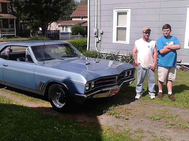 Zach Benedict, right, stands alongside his father and his grandfathers 1967 Buick.