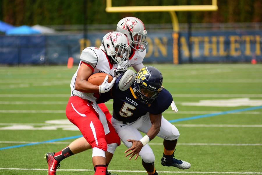 Pictured above is senior All-American  Omar Richardson #5 tackeling  a Muhlenberg player. 