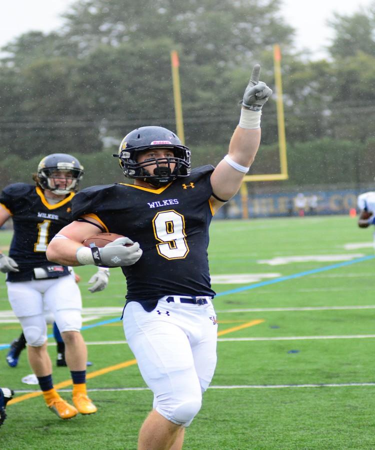 Jeremy Hartman points to his family in the stands after scoring a touchdown