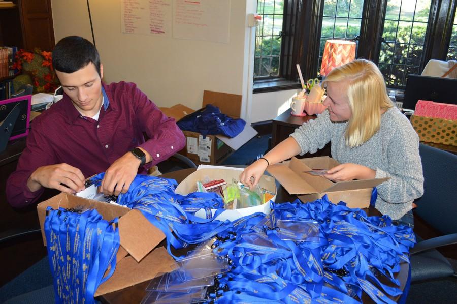 At left: Anthony Fanucci and Makia Stocker prepare for homecoming festivities in the Alumni office. 
“Family of Colonels” is the theme for Wilkes Homecoming 2015. It will take place Friday, Oct. 2 through Sunday, Oct. 4, with various activities thoughout the weekend.