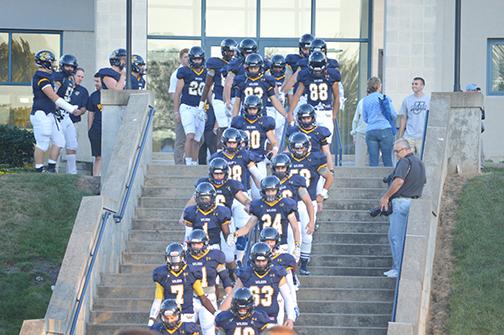 Colonels march down the stairs before last Friday’s game. 