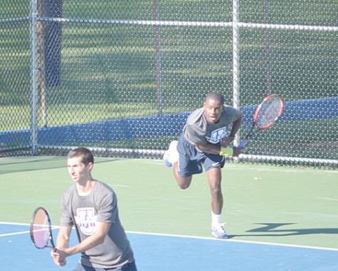 Member of men’s tennis team recovers from serve at last week’s match. 