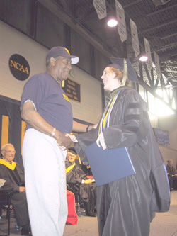 Above: Bill Cosby shakes hands with a graduate during the May 15, 2004 commencement activities.