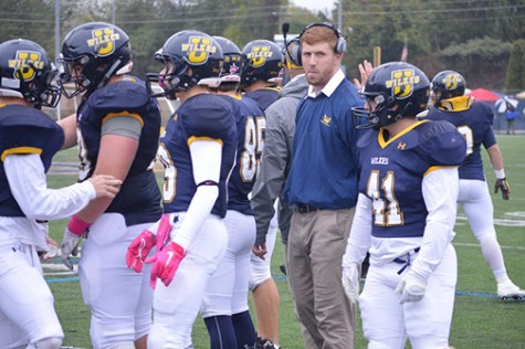 Hartman shares a moment with his team during a timeout the Homecoming game against Widener.