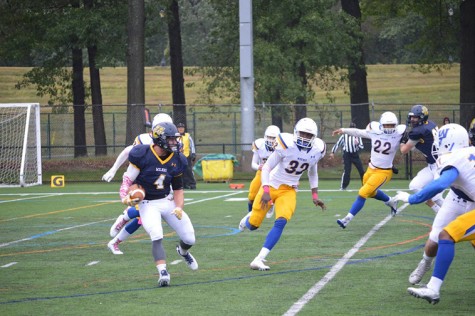 Wide Receiver Brett Ribellino runs the ball against a strong pride defense.