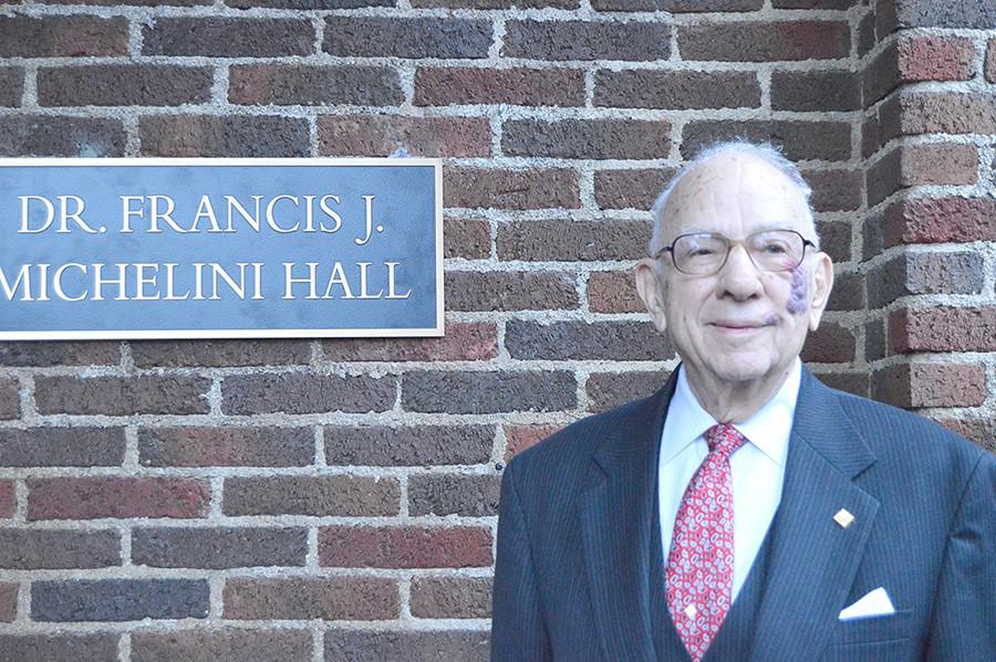 Dr.+Francis+Michelini+stands+infront+of+the+newly+renamed+Michelini+Hall+after+the+dedication+ceremony.