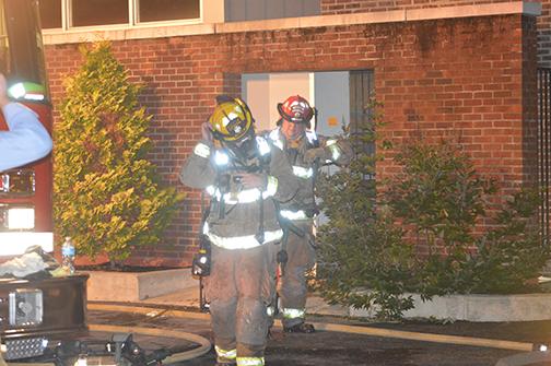 Firefighters leaving Bedford Hall after checking the inside of the building.
