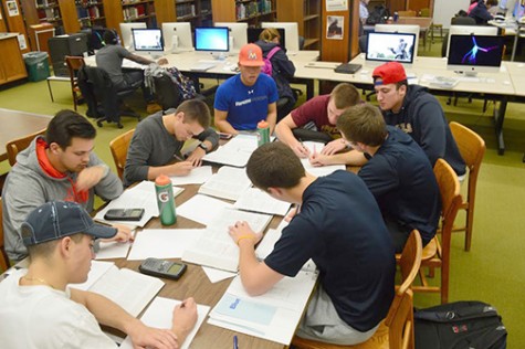 Clockwise: Matt Kaster, baseball (maroon shirt); Alex Kramer, baseball; Matthew Reese, baseball; Forrest Jordan, baseball; Mike Fleck, wrestling; Arlindo Isidoro, golf; Tyler Sutto, cross country; and Johnny Jan Jr., baseball, work on assignments at the Wilkes library.