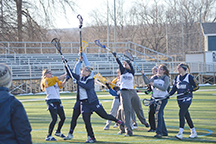 The team looks to catch a fly ball in practice.