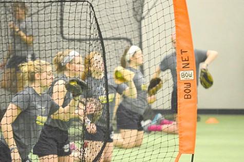 Wilkes Softball players warm up their throwing before practice.