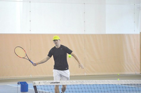Adam Lefkandinos delivers the tennis ball to his teammate during a practice.