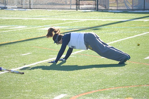 Lacrosse player Melanie Rivera punished with push-ups for not scooping a ball with both  hands on the stick by her coach.