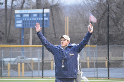 Curtis Jaques signaling to his players on the field  at a recent practice.