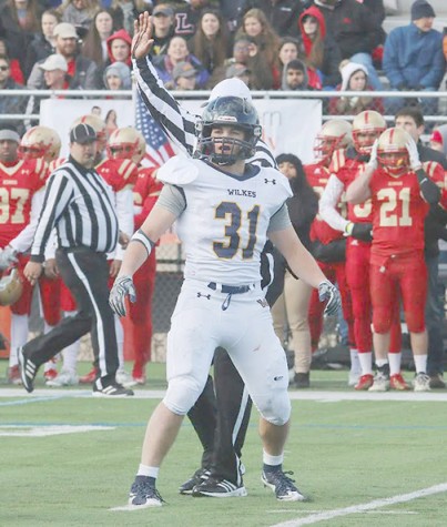 Tanner Stengel looks to the sidelines to receive the play call at the Wilkes/King’s game.