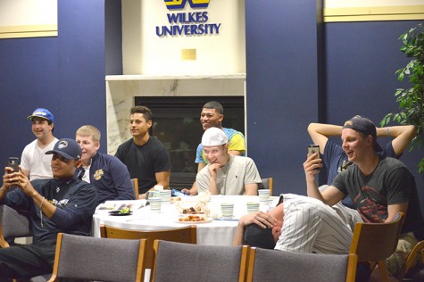 The baseball team reacts with laughter to Kramer’s roast.