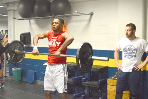 Men’s basketball freshman Marcus Robinson performs a hang clean as a part of his offseason workout at Martz.