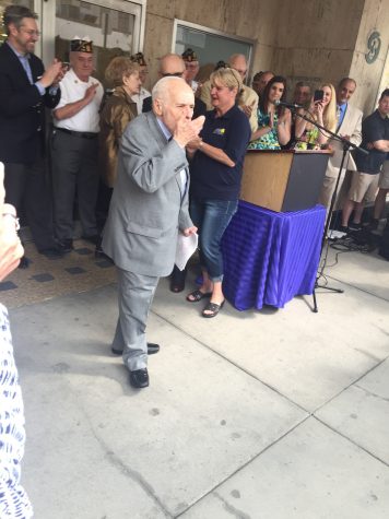 Albert Boscov blows kisses to his employees as he leaves his newly revamped department store.