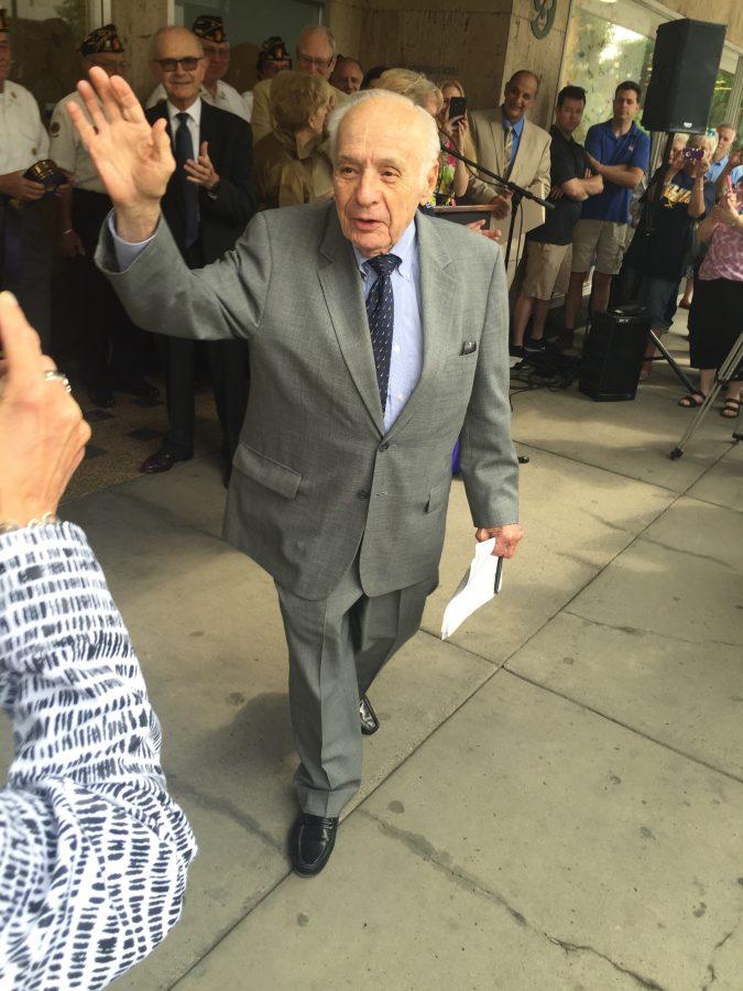 Albert Boscov waves to employees of the Wilkes-Barre store as he enters the ribbon cutting ceremony.