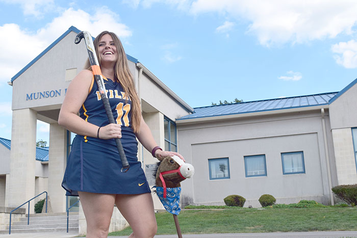 Junior Amanda Thompson poses with the teams stickhorse