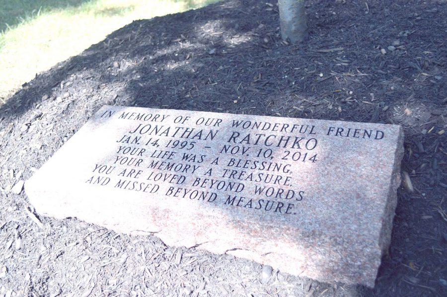 The memorial dedicated to Jonathan Ratchko that lies under the tree outside of Kirby Hall. 