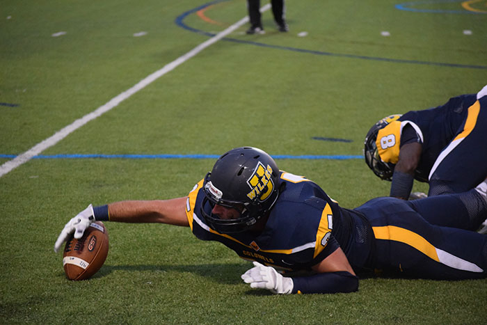 Sophomore Michael Murphy #25 dives for a loose ball in the home opener at Schmidt Stadium.