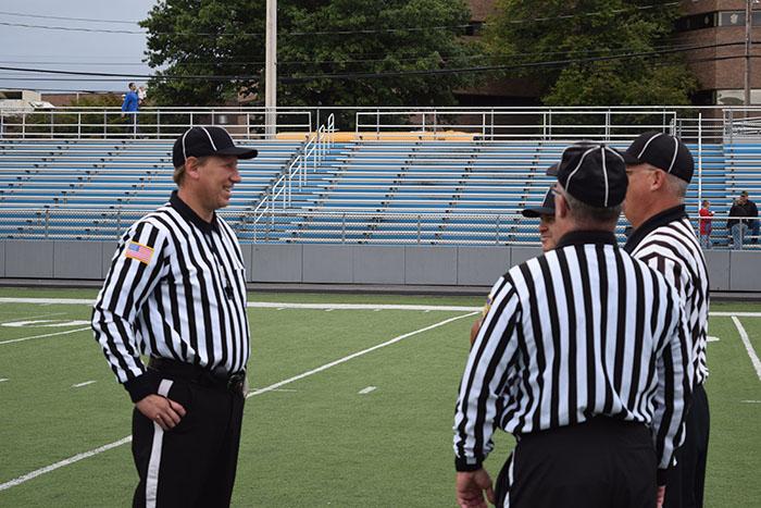 Official Steve Grzymski chats with his crew-mates during a break in play at Wilkes-Barre Memorial Stadium.