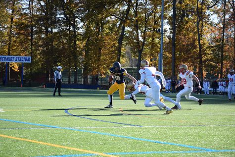 #18 Jeff Steeber wards off a King's defenders in an effort to secure the pass.