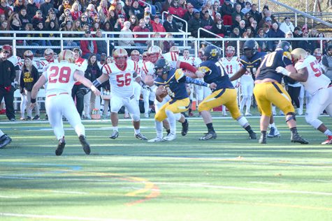 #4 Joe Tabora looks for a gap upfield as #70 Ryan Bowman and #75 Anthony Marcincavage block.