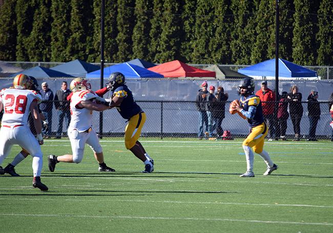 #74 Mike Osayi gives extra time for #4 Jose Tabora to complete a pass downfield.