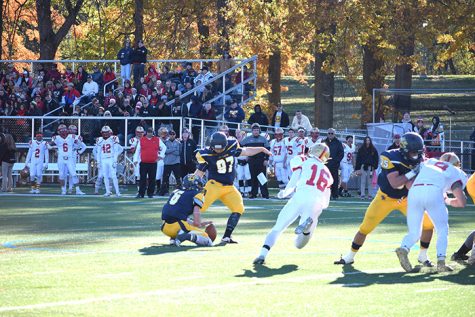 #97 Mike Hauck kicks an extra point held by #6 William Deemer.