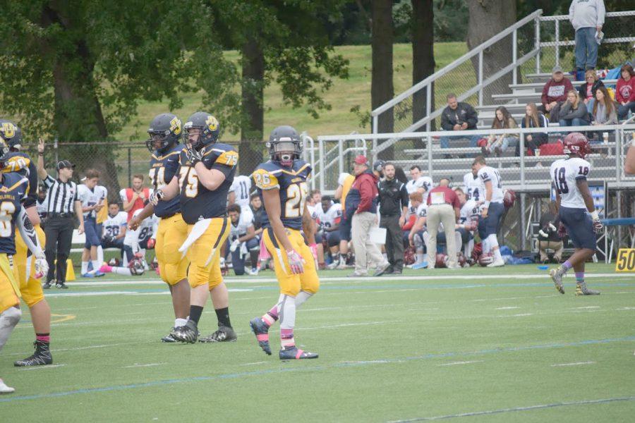 Wilkes #26 Devon Fink and #75 Anthony Marcincavage look to the sideline.