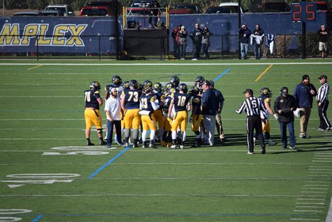 Coach Trey Brown tries to rally his players early in the first quarter.