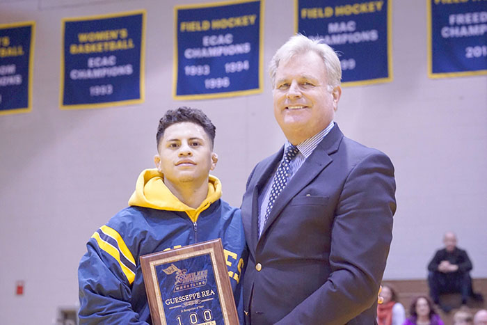 Dr. Paul Adams hands Guesseppe Rea a plaque for his 100th career victory.