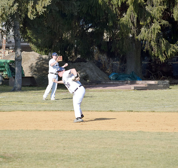 #26 Joe Champi throws to first base.