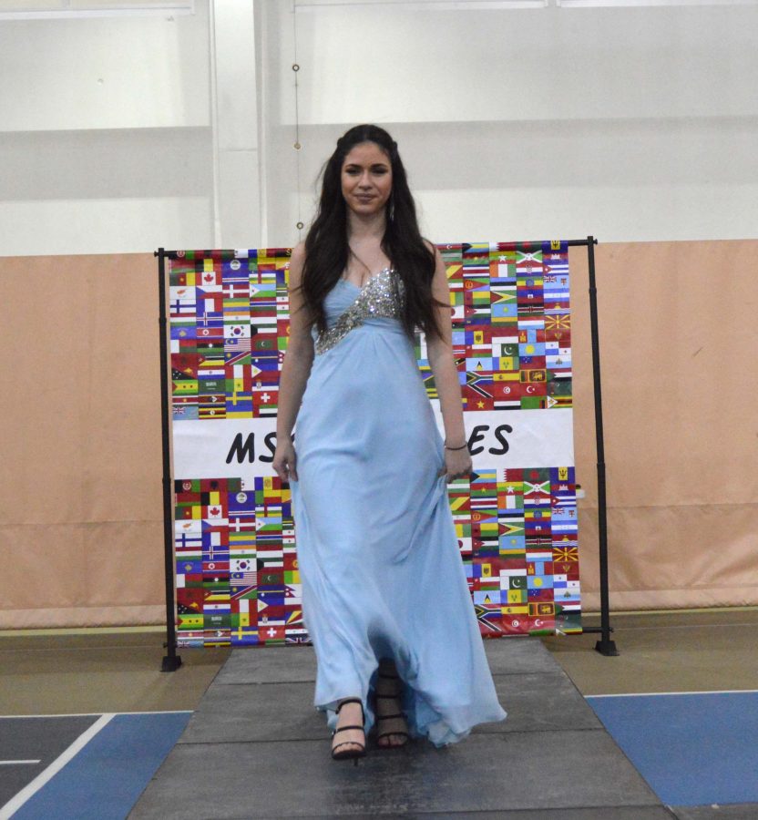 Freshman Maria Dima walks the runway in a periwinkle bedazzled gown.