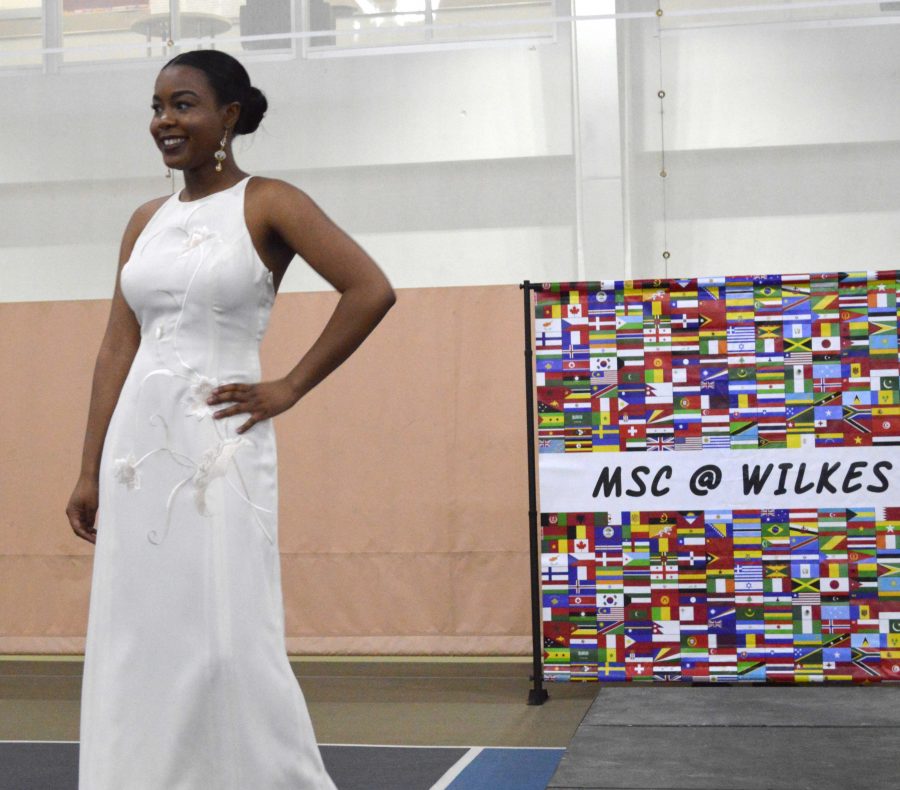 Sophomore Ymari Williams struts her stuff in a white gown.