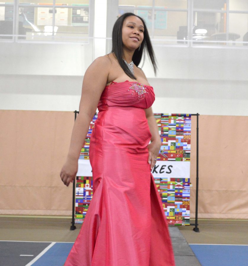 Junior Ana Castillo walks the runway in a pink fit and flare.