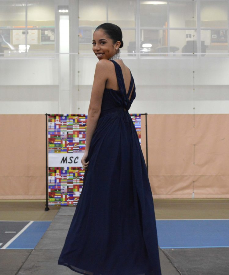 Ashley Rosa shows the back of her dress at the show.