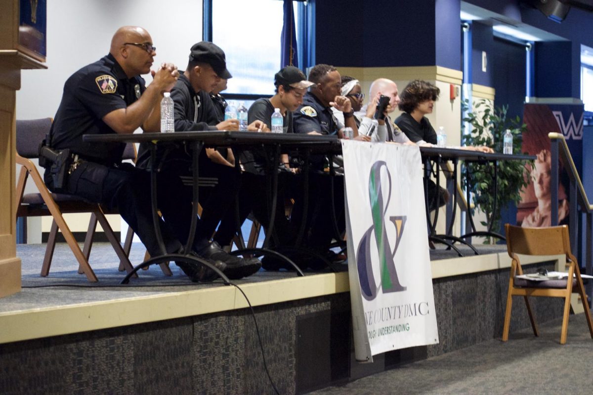 The panel of local police officers and youth working to reach an understanding through discussion of common misunderstandings in city crime. 