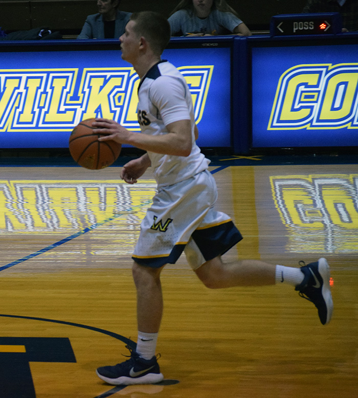 A Wilkes player dribbling up court. 