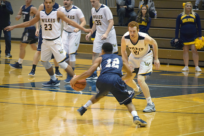 Johnny Bamford (#21) defending the ball against Messiah. 