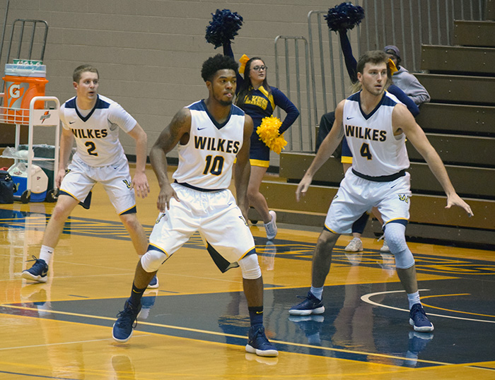 Marcus Robinson (#10), Tommy Bowen (#4) and Landon Henry (#2) defending the basket for Wilkes. 