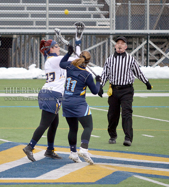 Kirsten Jackson (#23) takes the faceoff.