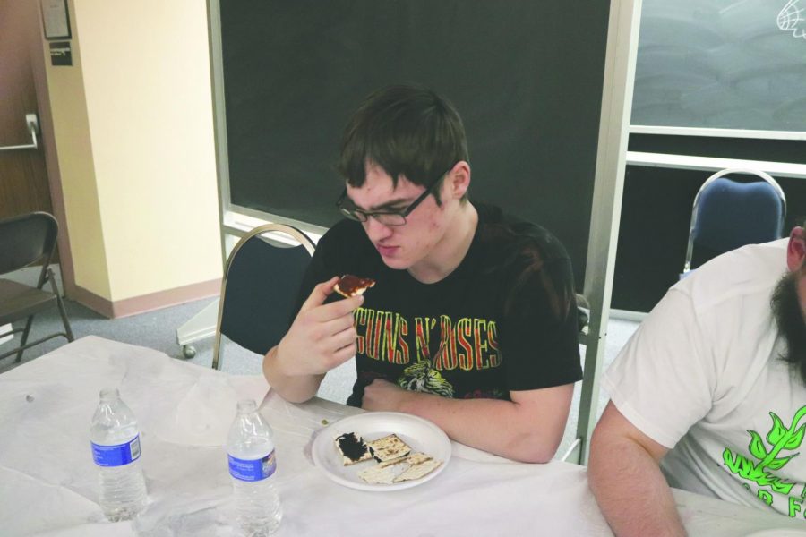 Daulton Moyer observes the vegemite and marmite spreads on his cracker suspiciously. 