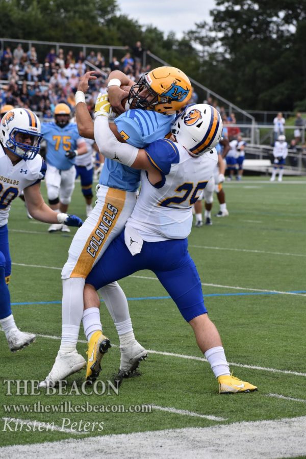 Junior Derek Nelson fights for yards with under a minute left in the first half.