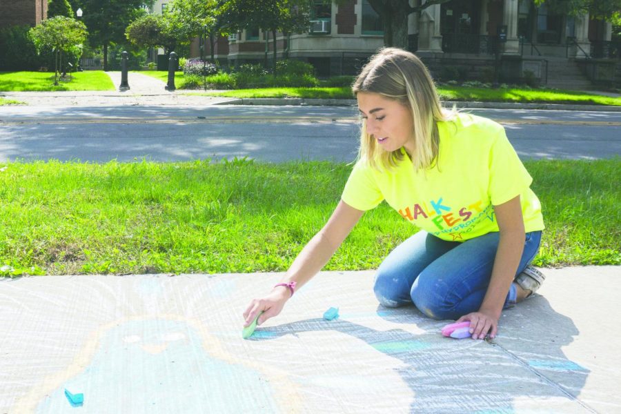 Taylor Hubiak, a sophomore business management major, contributed to the chalk drawing. 