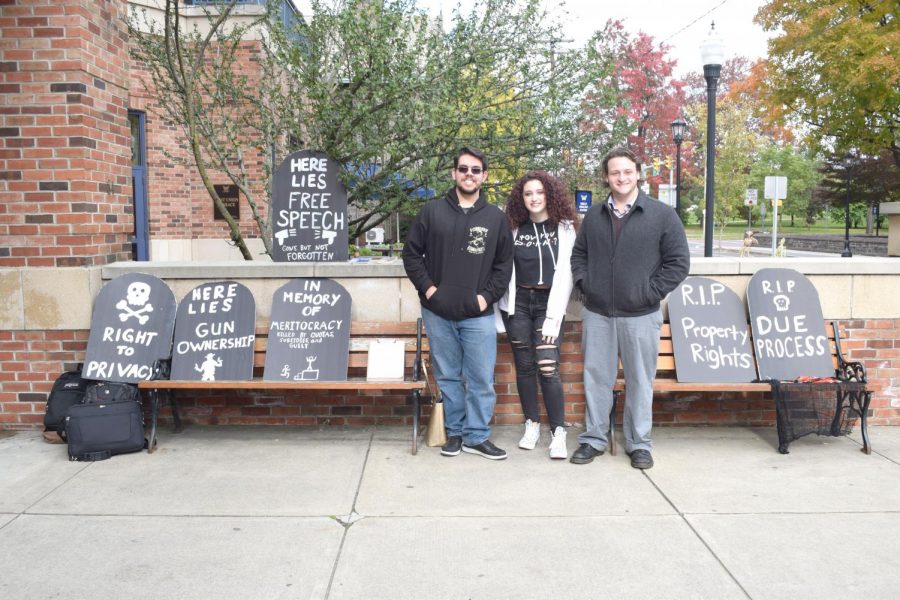 Three Young Liberitarians pose in front of their constitutional rights posters.